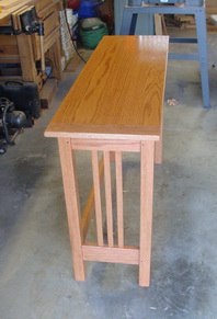 This is a clean little mission-style table in oak. 